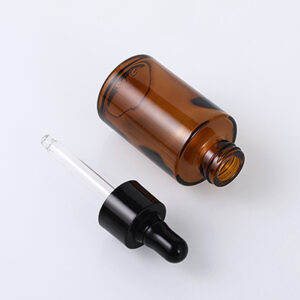 empty amber glass serum bottle with dropper