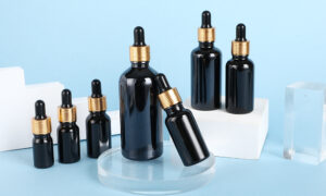 black skin care glass dropper bottle with gold collar