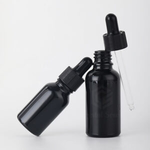 empty black hair oil bottle